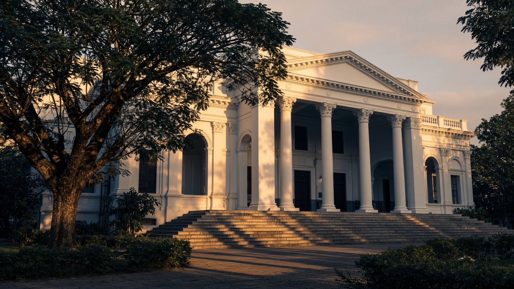 A historic civic courthouse in Kerala at golden hour.